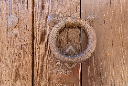 Albaicin, Province of Granada, Andalusia, Spain. Old iron knocker on a painted wooden door. Art Print